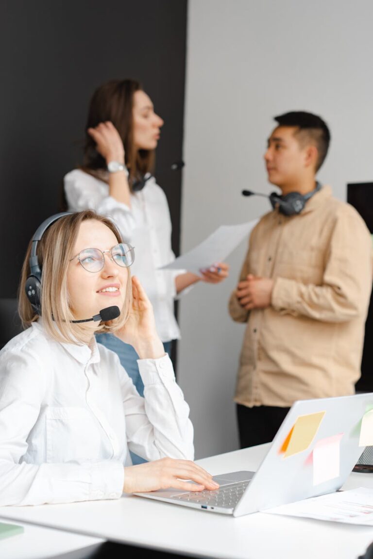 woman in a white shirt working on her laptop